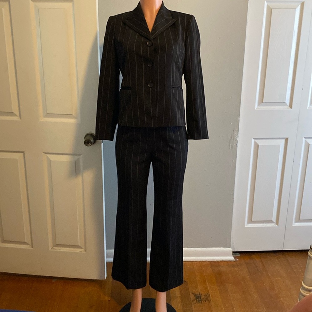 Women’s two piece black striped suit.